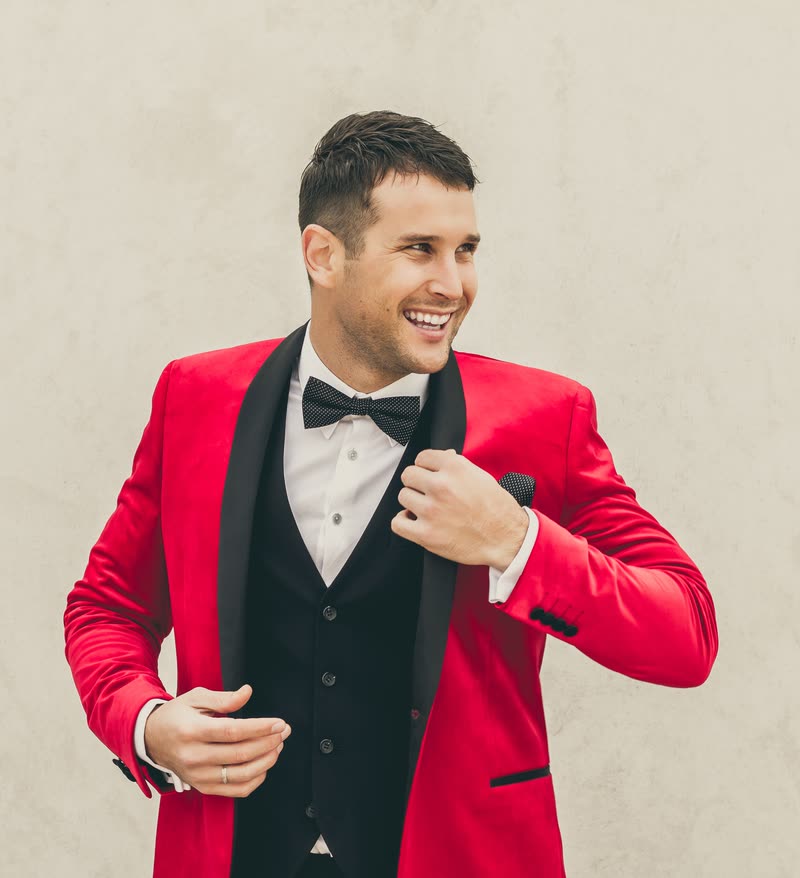 Sam Ludeman laughing in the red velvet jacket